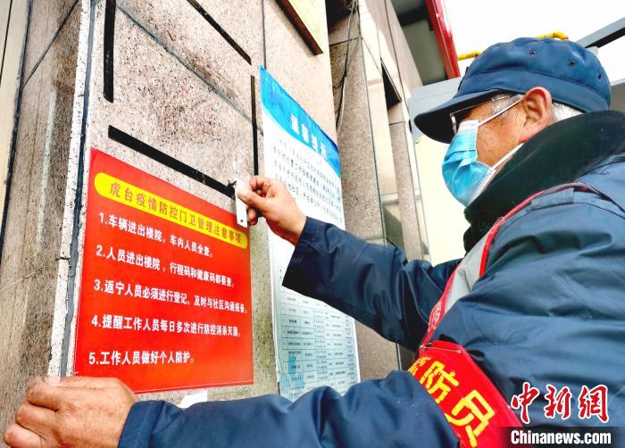 图为青海省西宁市一小区工作人员清理旧有的相关疫情提示。 张添福 摄 图为青海省西宁市一小区工作人员清理旧有的相关疫情提示。 张添福 摄